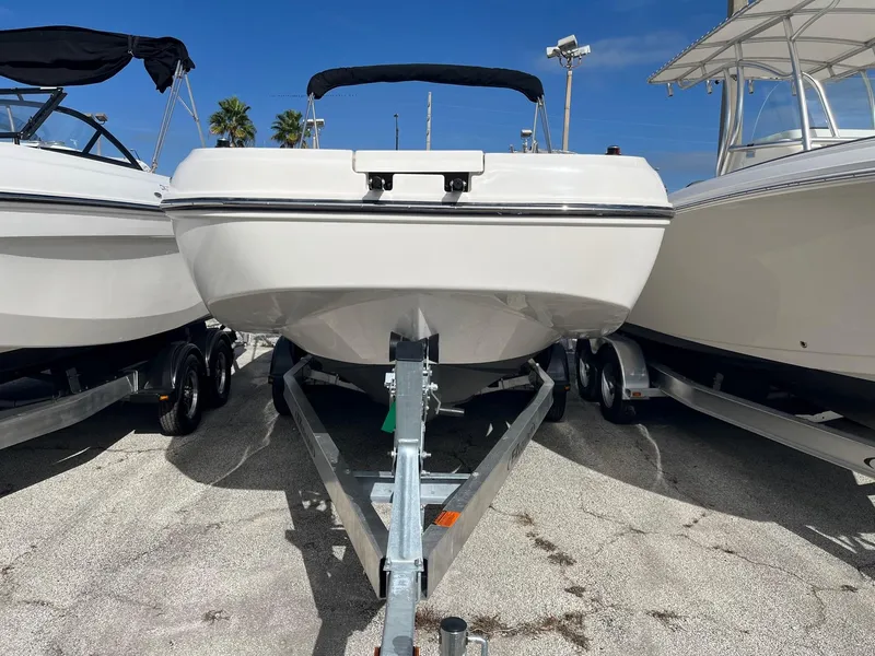 Slide: The Image of 2021 Bayliner DX 2200 boat on a trailer, front view. - 3