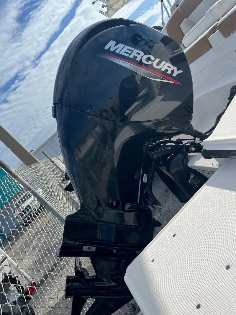 Slide: The Image of 2021 Bayliner DX 2200 boat interior with seating and canopy. - 5