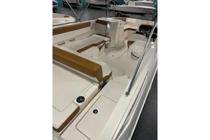 Slide: The Image of 2021 Bayliner DX 2200 boat interior with tan seating and white deck. - 7
