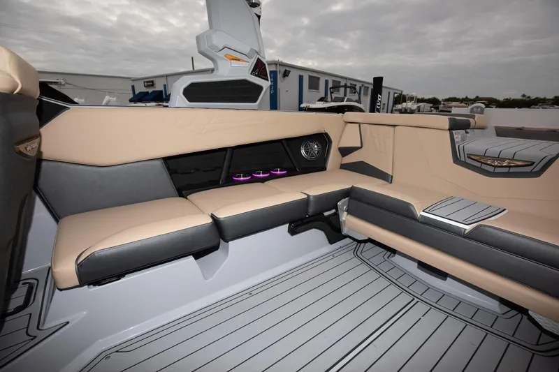Slide: The Image of 2024 Nautique Super Air Nautique S23 interior seating with modern design and ambient lighting. - 10