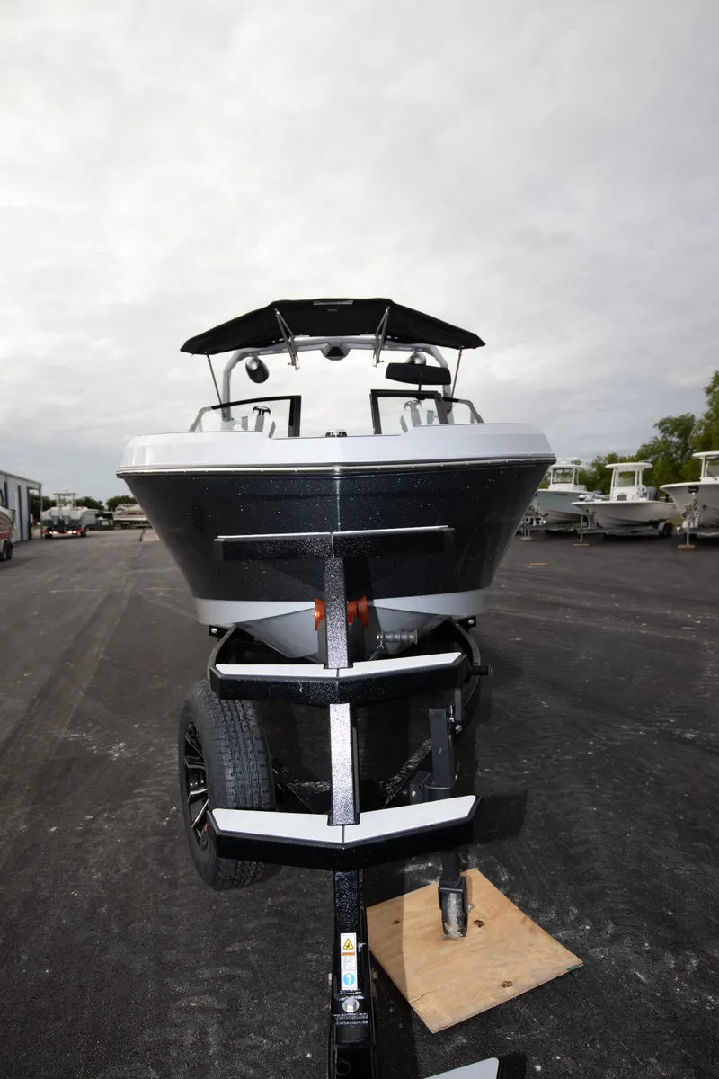 Slide: The Image of 2024 Nautique Super Air Nautique S23 boat on trailer, front view. - 14