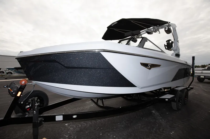 Slide: The Image of 2024 Nautique Super Air Nautique S23 boat on trailer, side view. - 15