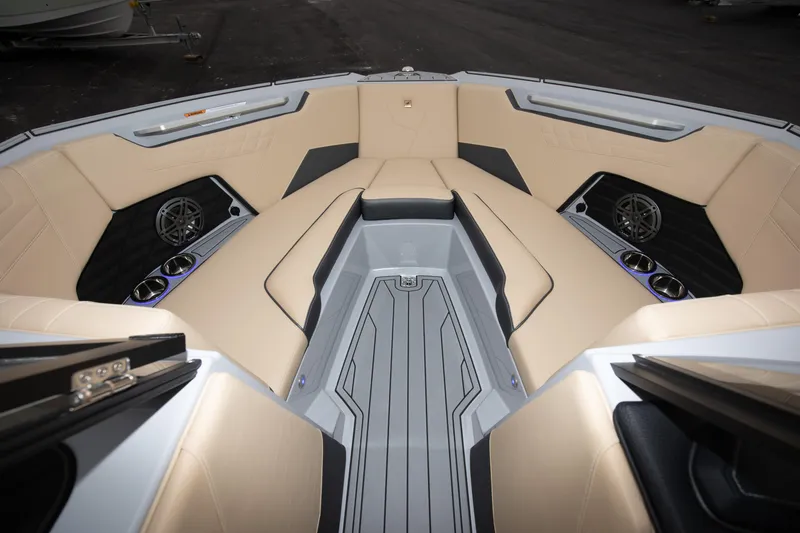 Slide: The Image of 2024 Nautique Super Air Nautique S23 boat interior with beige seating and modern design. - 2