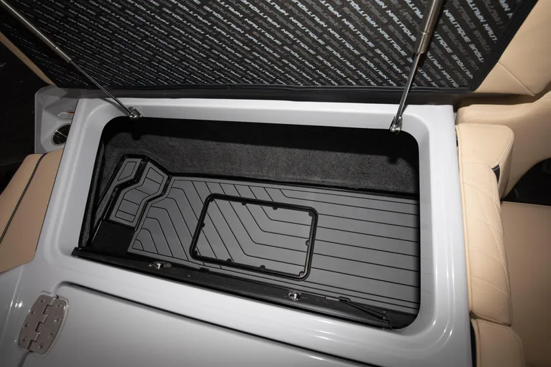 Slide: The Image of 2024 Nautique Super Air Nautique S23 storage compartment with open lid. - 20