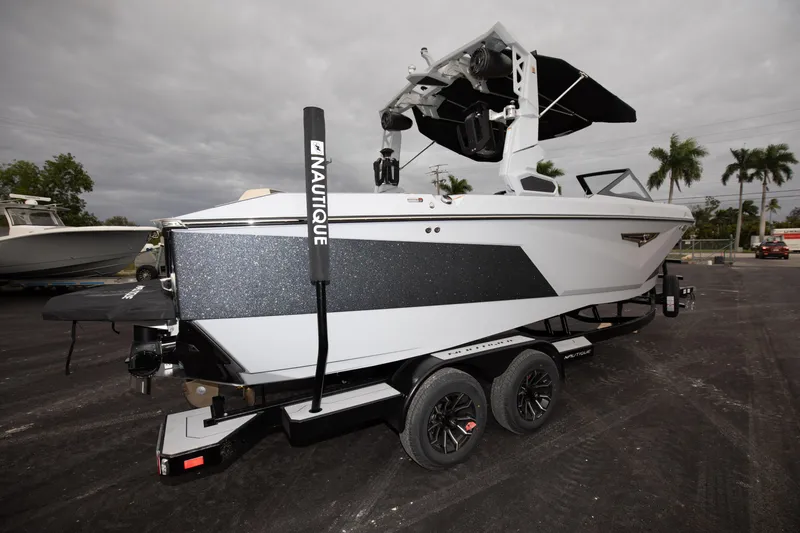 Slide: The Image of 2024 Nautique Super Air Nautique S23 boat on trailer, side view. - 5