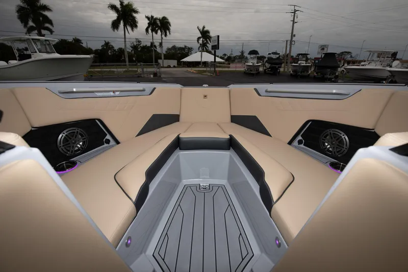 Slide: The Image of 2024 Nautique Super Air Nautique S23 boat interior with beige seating and modern design. - 6