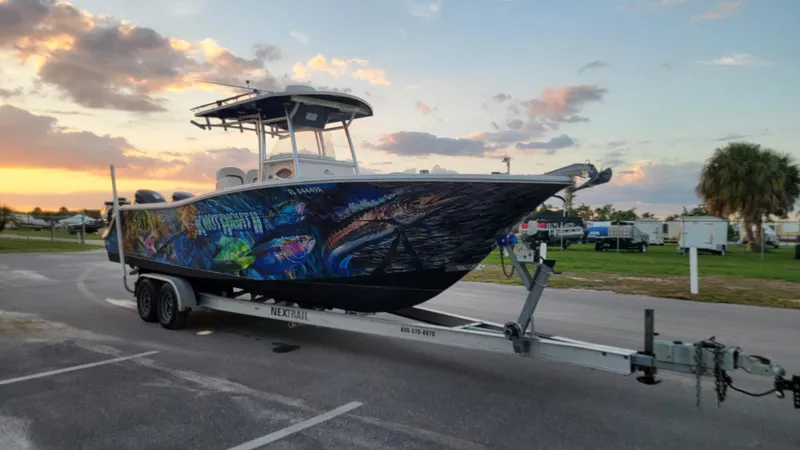 Slide: The Image of 2010 Sea Fox 286 Commander boat on trailer at sunset, featuring vibrant marine graphics. - 3