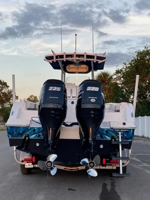 Slide: The Image of 2010 Sea Fox 286 Commander boat with twin 225 horsepower engines, parked outdoors. - 4