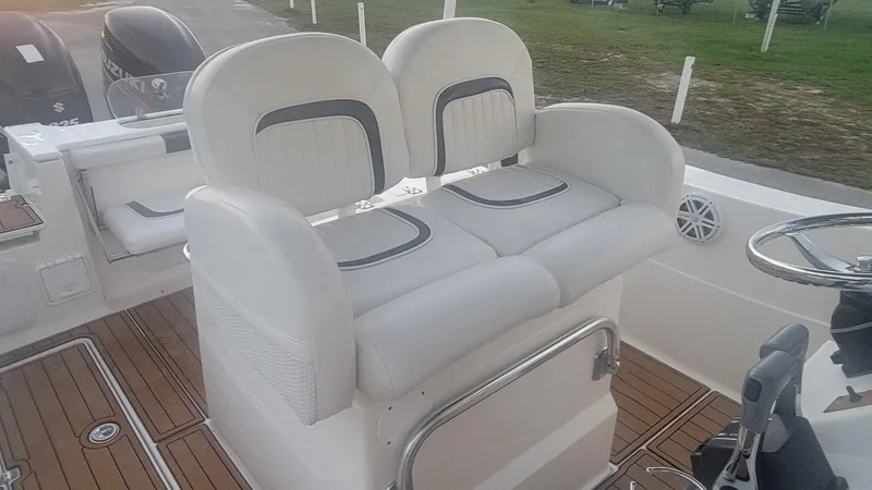 Slide: The Image of 2010 Sea Fox 286 Commander boat interior with dual white cushioned seats. - 8
