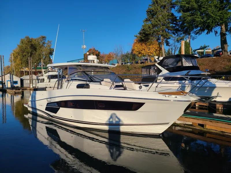 The Image of 2021 Jeanneau Leader 12.5 boat docked in a marina on a sunny day. - 0