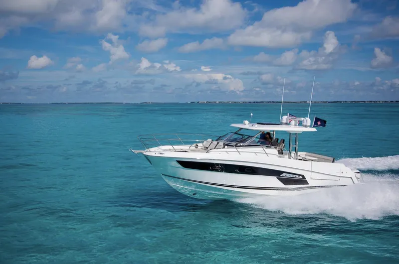 Slide: The Image of 2021 Jeanneau Leader 12.5 cruising on clear blue water under a partly cloudy sky. - 4