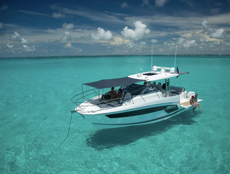 Slide: The Image of 2021 Jeanneau Leader 12.5 motorboat on clear turquoise water. - 5