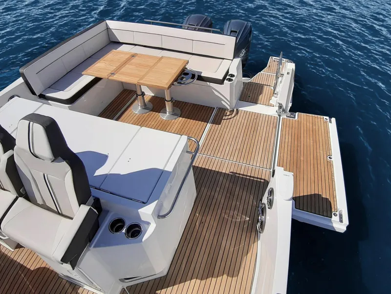 Slide: The Image of 2021 Jeanneau Leader 12.5 boat with spacious deck and seating area. - 8