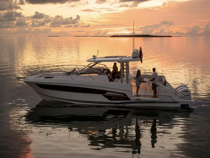 Slide: The Image of 2021 Jeanneau Leader 12.5 boat at sunset with people onboard. - 9