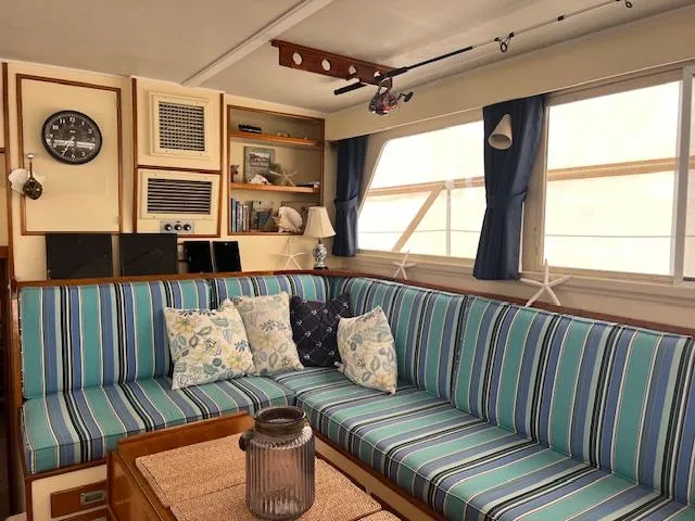 Slide: The Image of Interior of 1972 Huckins Atlantic 50 yacht with striped seating and nautical decor. - 9