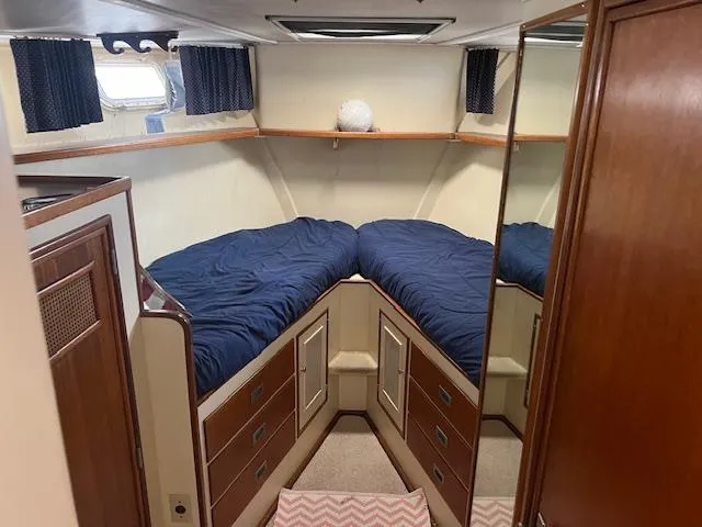 Slide: The Image of 1972 Huckins Atlantic 50 boat cabin with twin beds and storage drawers. - 3
