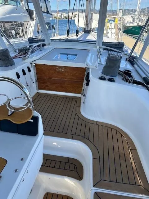 Slide: The Image of 2009 Catalina 470 yacht cockpit with teak flooring and steering wheel, docked at marina. - 20