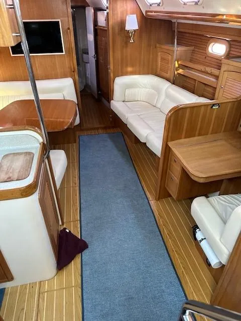 Slide: The Image of Interior of 2009 Catalina 470 yacht with wooden flooring and comfortable seating. - 40