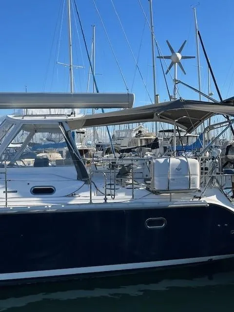Slide: The Image of Catalina 470 sailboat, 2009 model, docked in a marina under clear blue skies. - 5
