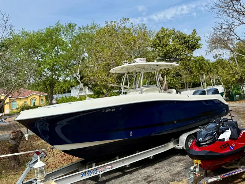 Slide: The Image of 2008 Hydra-Sports Vector 2900 CC boat on trailer, surrounded by trees. - 2