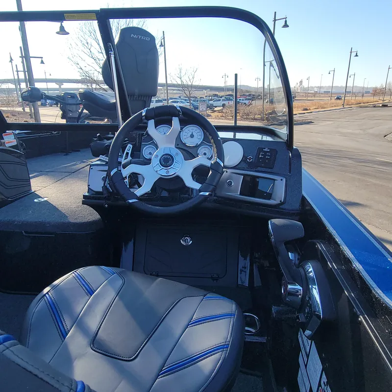 Slide: The Image of 2024 Nitro ZV20 Pro boat cockpit with steering wheel and control panel. - 2