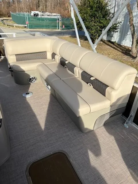 Slide: The Image of 2024 Sun Tracker Sportfish 24 XP3 pontoon boat with beige seating and spacious deck. - 11