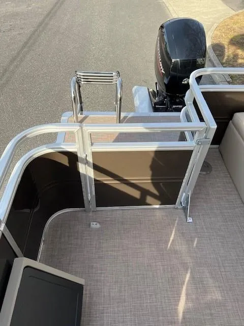 Slide: The Image of 2024 Sun Tracker Sportfish 24 XP3 pontoon boat with outboard motor and rear entry gate. - 15