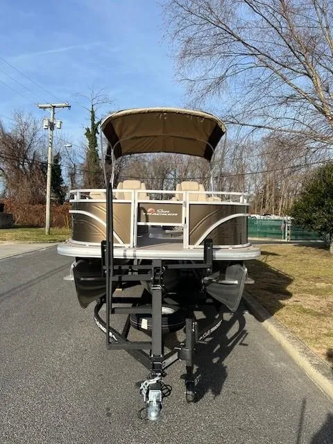 Slide: The Image of 2024 Sun Tracker Sportfish 24 XP3 pontoon boat on a trailer. - 2