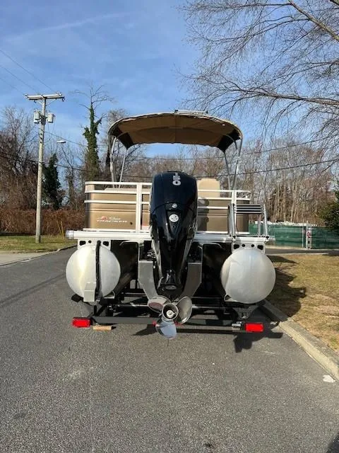 Slide: The Image of 2024 Sun Tracker Sportfish 24 XP3 pontoon boat on a trailer. - 4