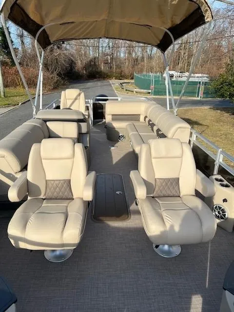 Slide: The Image of 2024 Sun Tracker Sportfish 24 XP3 pontoon boat with beige seating and canopy. - 7