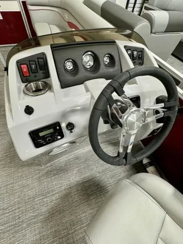 Slide: The Image of 2024 Bennington 20 SSR boat dashboard with steering wheel and control panel. - 10