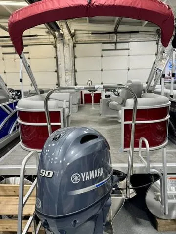Slide: The Image of 2024 Bennington 20 SSR pontoon boat with Yamaha 90 outboard motor in showroom. - 18