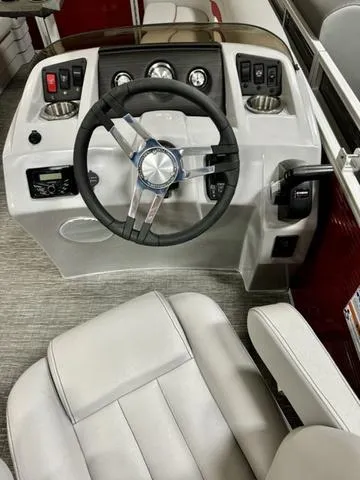 Slide: The Image of 2024 Bennington 20 SSR boat dashboard with steering wheel and control panel. - 6