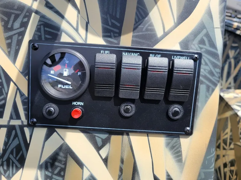 Slide: The Image of 2025 Smoker Craft Freedom 160 CC center console camo fuel gauge and control panel. - 10