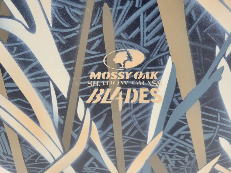 Slide: The Image of Mossy Oak Shadow Grass Blades camo pattern on 2025 Smoker Craft Freedom 160 CC center console. - 3