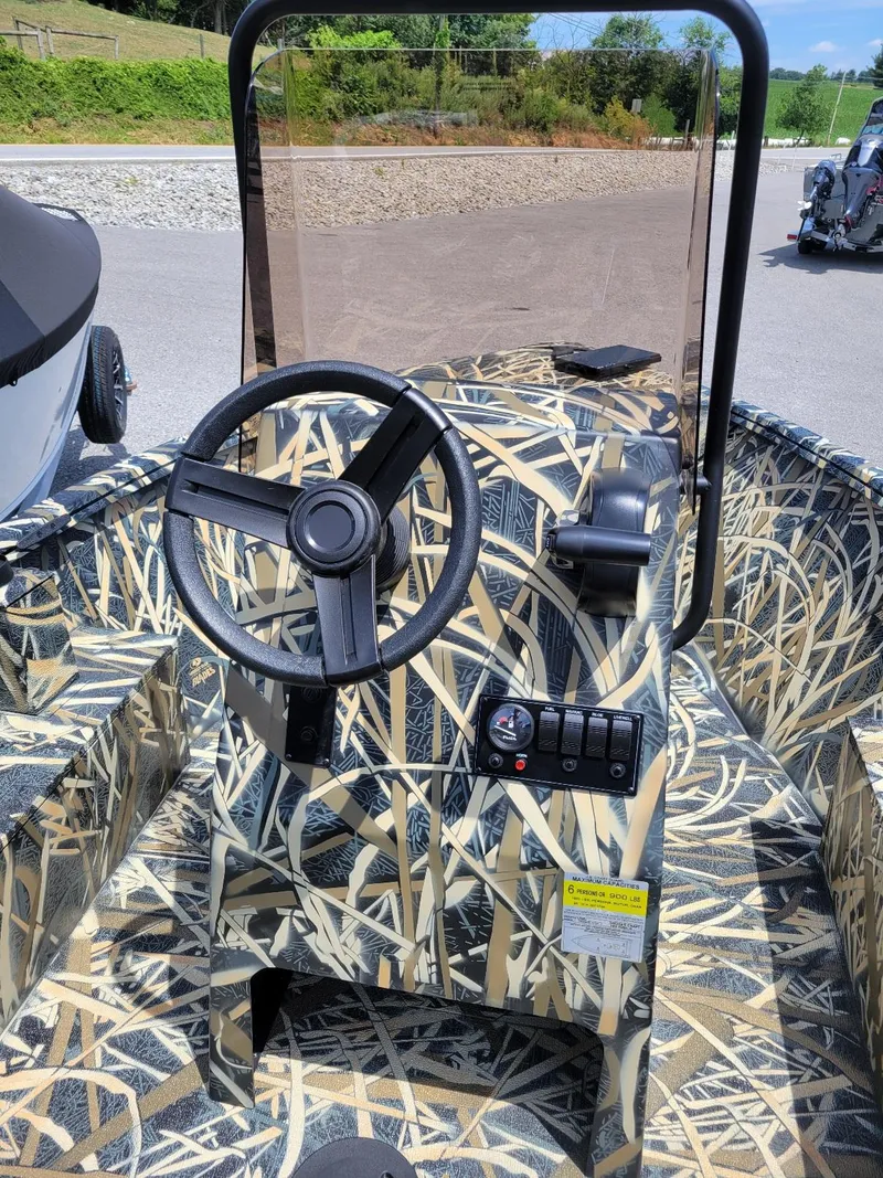 Slide: The Image of 2025 Smoker Craft Freedom 160 CC center console boat with camo design, in stock. - 6