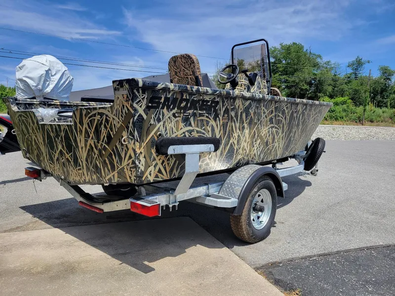 Slide: The Image of 2025 Smoker Craft Freedom 160 CC center console camo boat on trailer. - 8