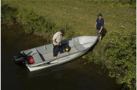Slide: The Image of 2024 Smoker Craft 15' Alaskan Tiller v-bottom boat on a grassy shore. - 10