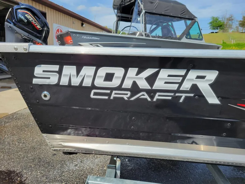 Slide: The Image of 2024 Smoker Craft 16 Big Fisherman DLX boat, black exterior, close-up view. - 5