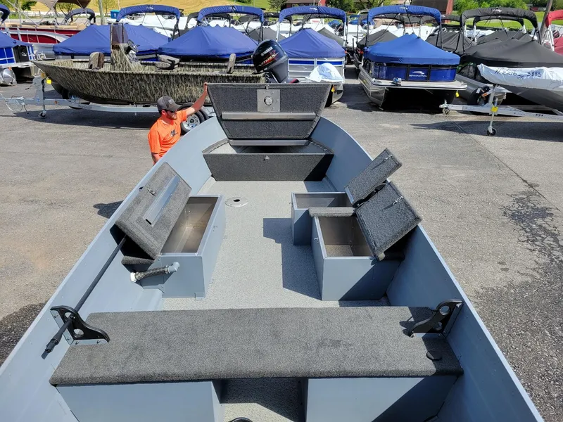 Slide: The Image of 2024 Smoker Craft 16 Big Fisherman DLX tiller boat, interior view with storage compartments. - 7