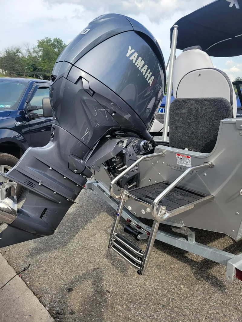 Slide: The Image of 2024 Smoker Craft Ultima Legacy 172 with Yamaha 150 engine, featuring a walk-thru windshield. - 12