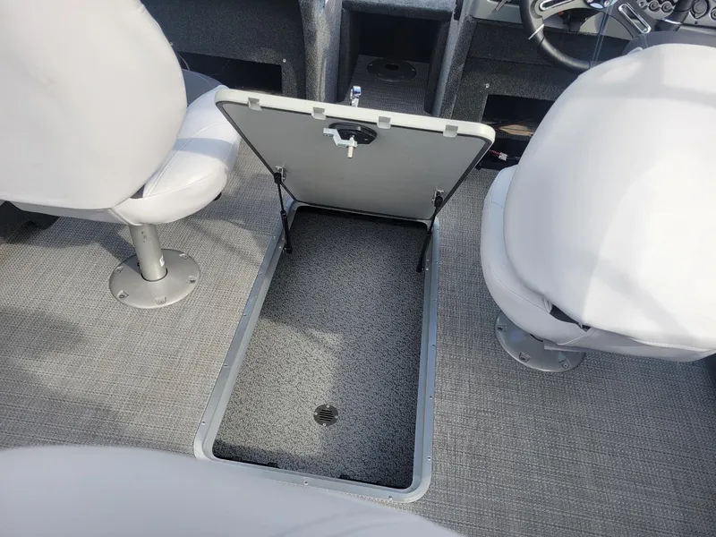 Slide: The Image of 2024 Smoker Craft Ultima Legacy 172 interior with open storage compartment and seating. - 17