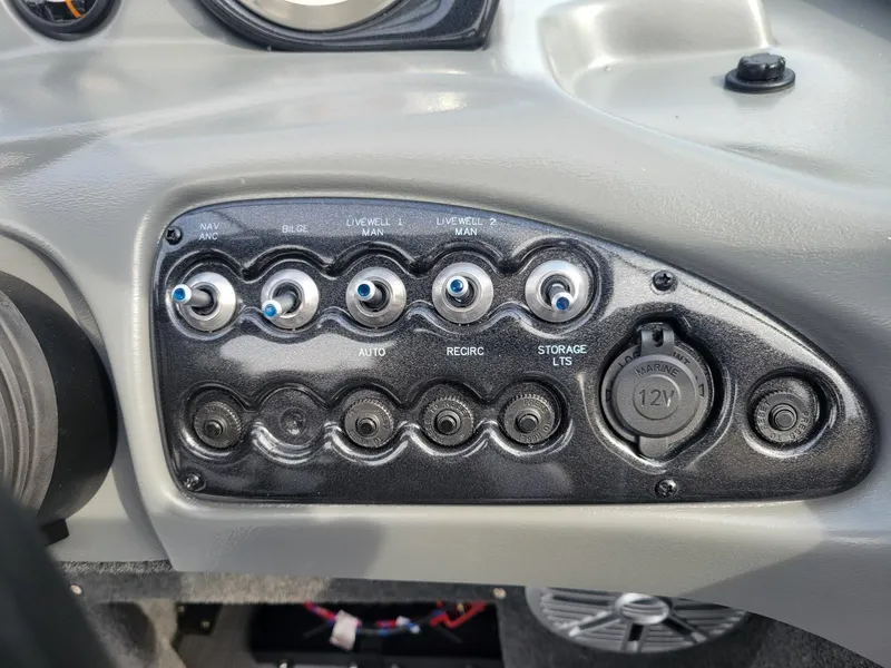 Slide: The Image of Control panel of 2024 Smoker Craft Ultima Legacy 172 boat with switches and 12V outlet. - 4