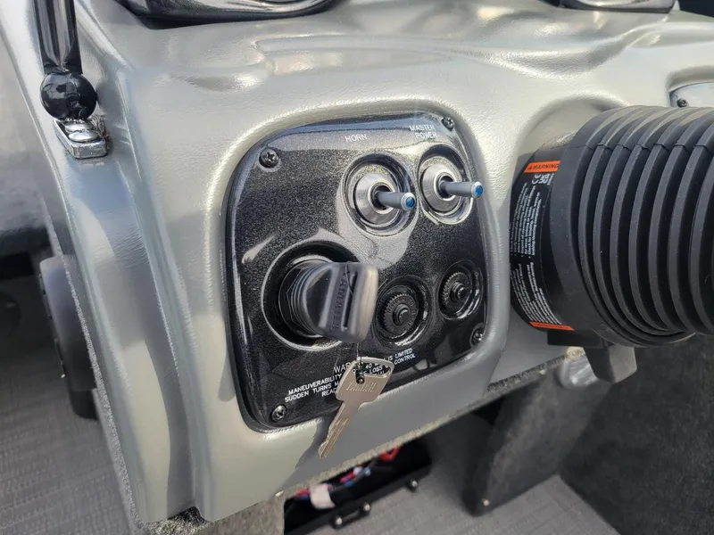 Slide: The Image of 2024 Smoker Craft Ultima Legacy 172 dashboard with ignition and control switches. - 5