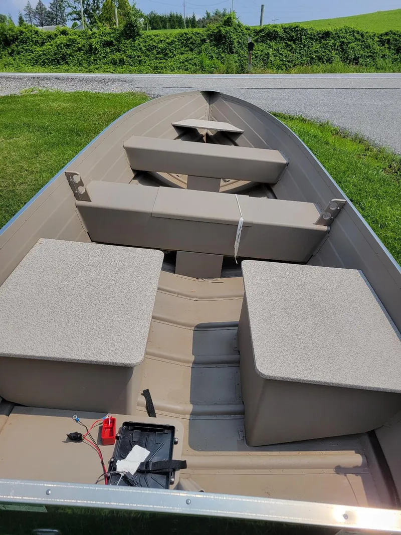 Slide: The Image of 2025 Smoker Craft 16 Voyager tiller boat interior, featuring seating and storage compartments. - 3