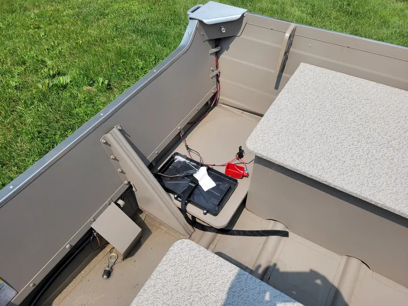 Slide: The Image of 2025 Smoker Craft 16 Voyager tiller interior, featuring seating and battery setup. - 5