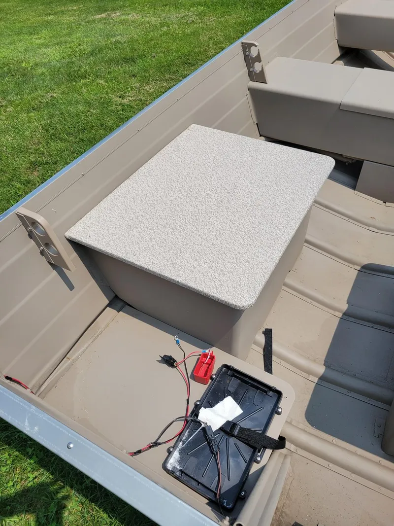 Slide: The Image of 2025 Smoker Craft 16 Voyager tiller interior with seating and battery compartment. - 9