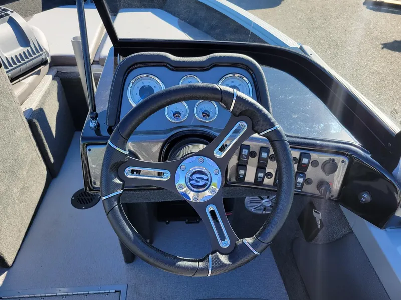 Slide: The Image of 2024 Smoker Craft Ultima 172 dashboard with steering wheel and control panel. - 8