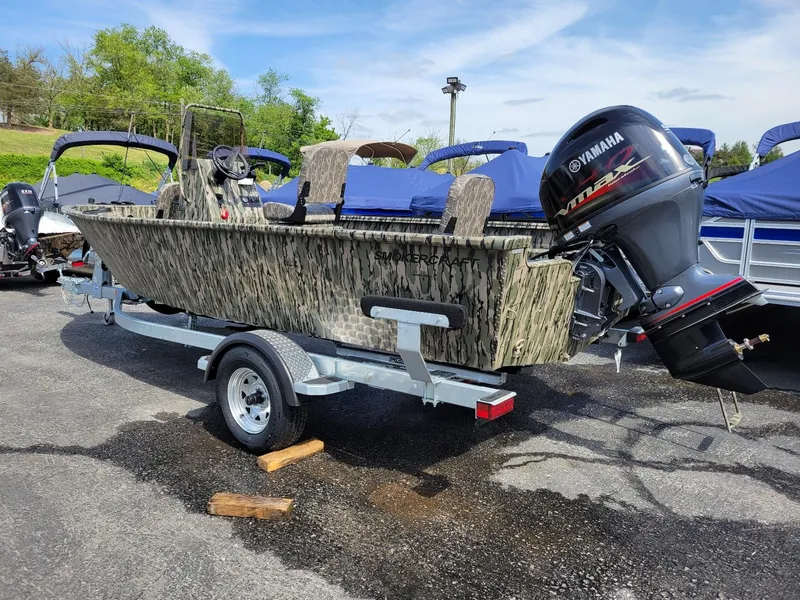 Slide: The Image of 2024 Smoker Craft Freedom 180 CC center console boat in camo, with Yamaha outboard motor. - 11