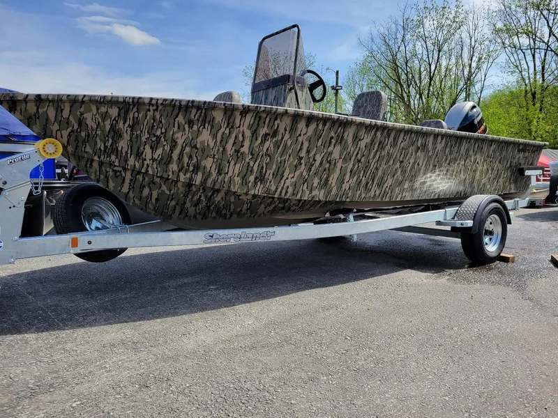 Slide: The Image of 2024 Smoker Craft Freedom 180 CC center console boat in camo, on a trailer. - 12
